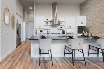 a kitchen with white cabinetry and a large island with a breakfast bar